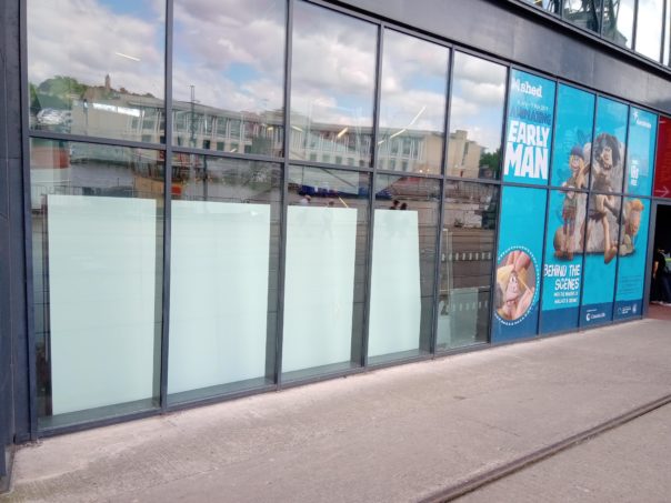 The photo shows four windows that now show the back of the retail bays so we need to apply graphics to the outside windows.